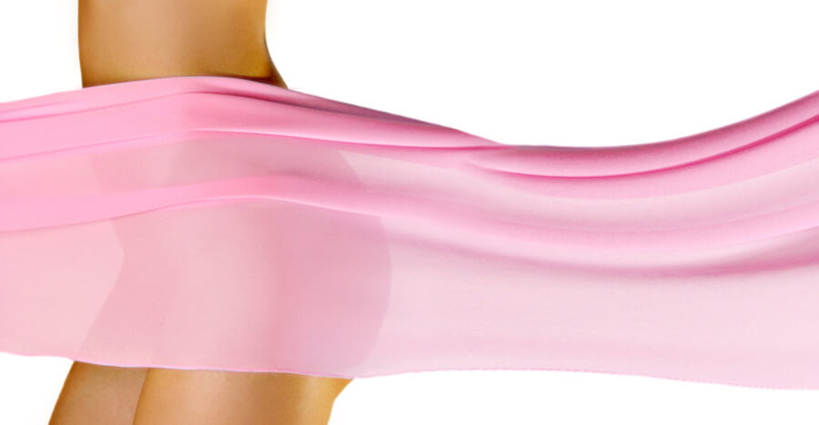 woman's hips behind pink silk fabric