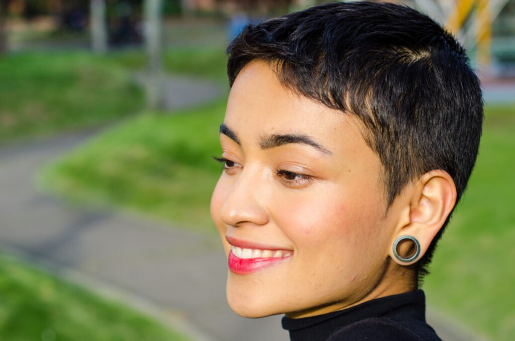 Woman with gauges in her ears who is a good candidate for earlobe repair surgery