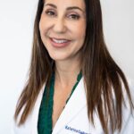 Dr. Katrina Gallus smiling in white coat
