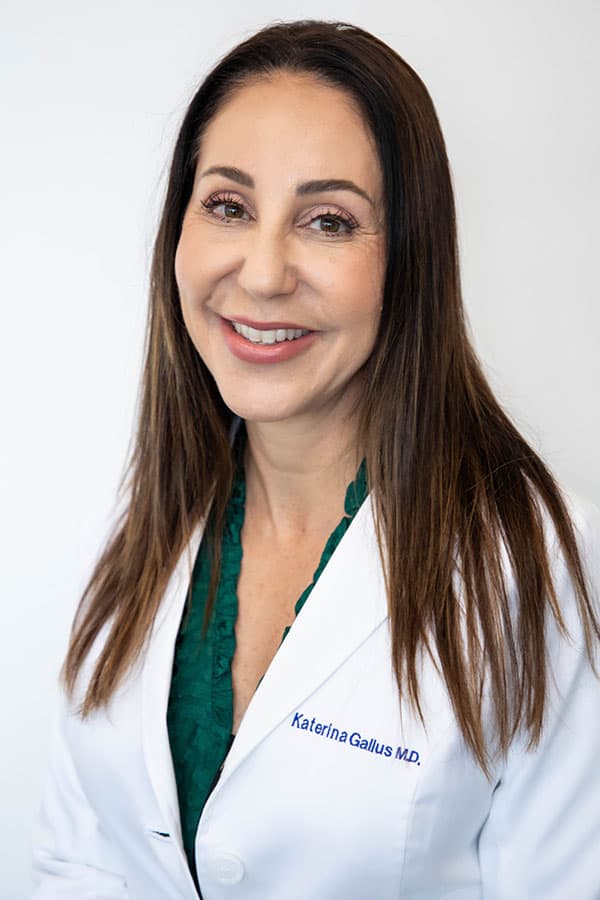 Dr. Katrina Gallus smiling in white coat
