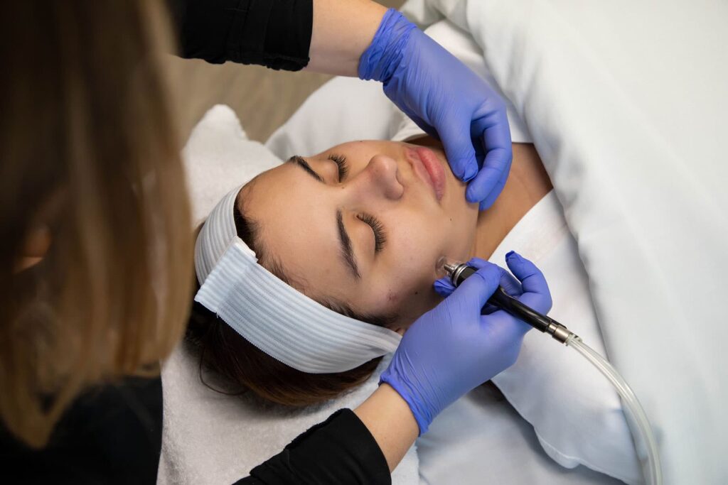 Aesthetician performing Diamond Glow Facial