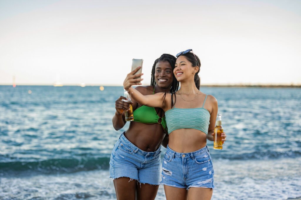 Two young women smiling and taking Instagram photos in La Jolla, California
