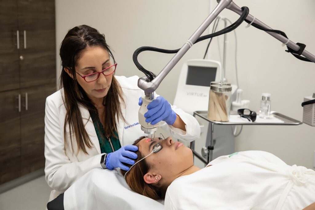 Dr. Katerina Gallus using a fractionated co2 laser skin resurfacing treatment on a skincare patient at her office in the La Jolla area of San Diego