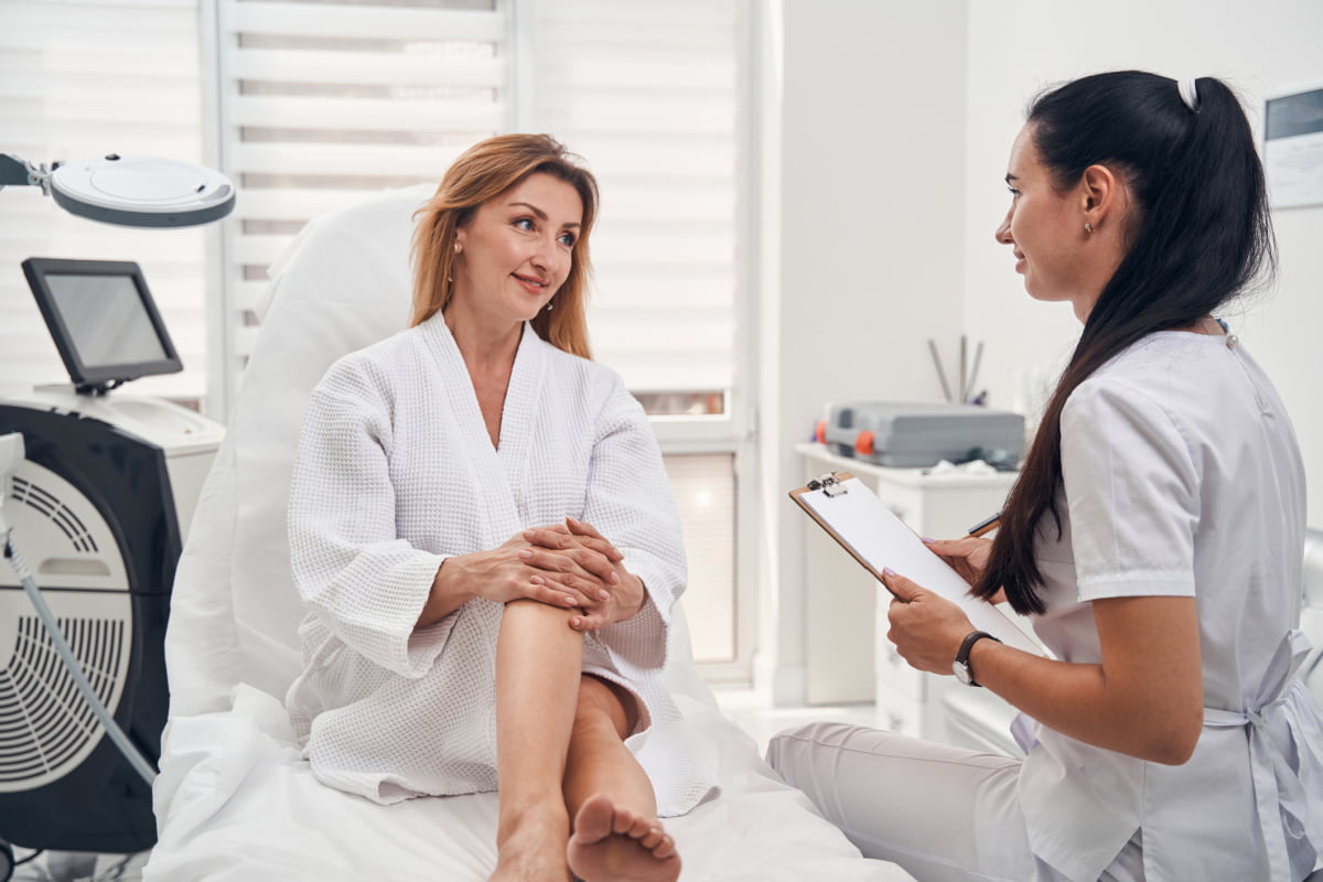 Mommy makeover patient going over checklist with plastic surgeon