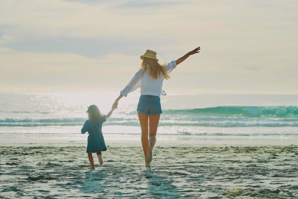 Mother and daughter on the beach during summer vacation
