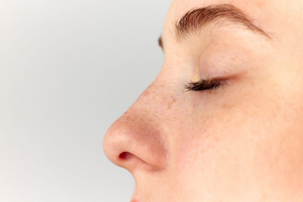 Close up of profile view of woman with a petite, refined nose tip