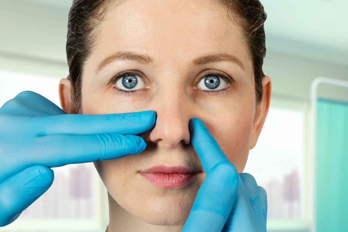 Woman at rhinoplasty consultation with plastic surgeon