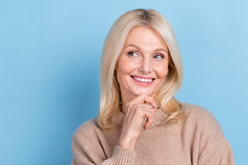 Mature woman smiling and looking off to the side